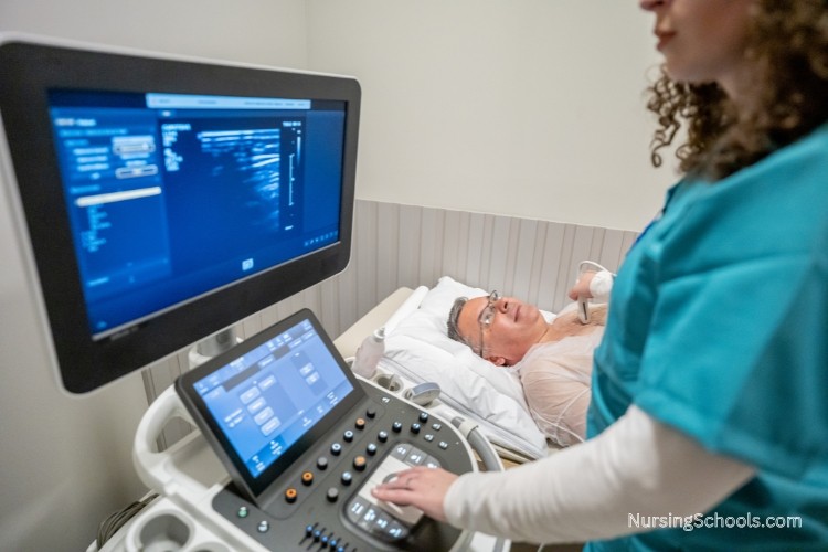 Cardiac Care Nurse assisting an echocardiogram cardiac procedure.