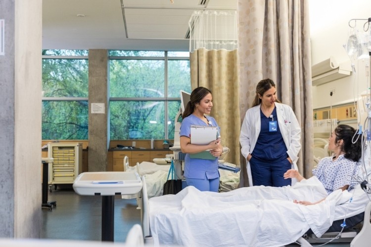 Clinical Nurse Leader (CNL) assesses a patient to help develop and implement a care plan.