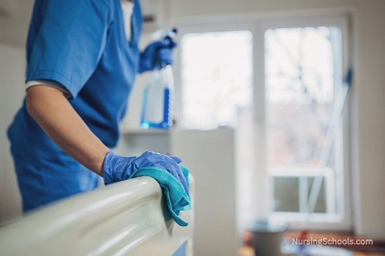 Nursing Assistant (NA) cleans patient areas using proper sanitation techniques as part of her job duties.