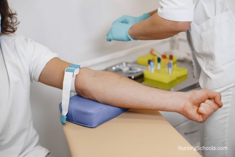 Correctional Nurse drawing blood during an intake screening as part of her job duties for assessing new admissions.