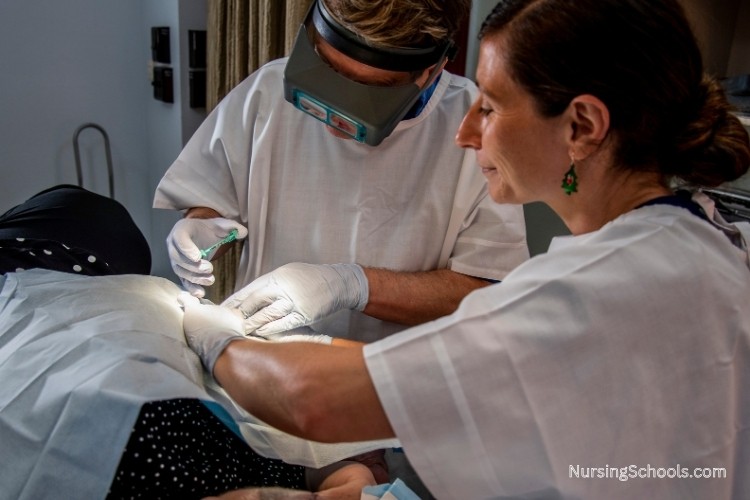 Dermatology Nurse assisting with an in-office procedure, such as a skin biopsy or wound care, as part of her job duties.