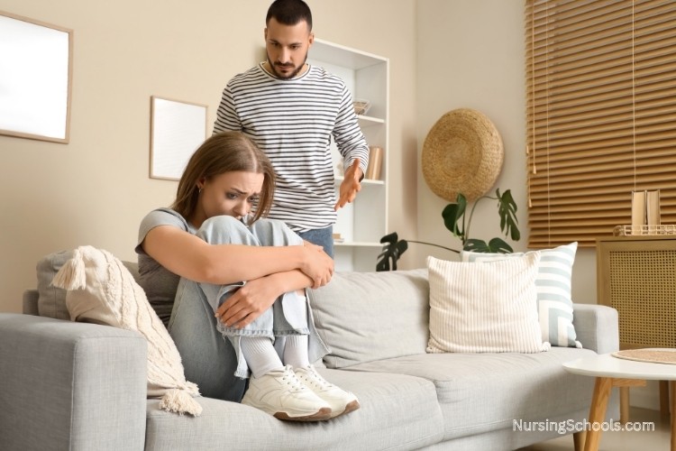 Upset woman during an argument at home, reflecting Domestic Violence Nurse job duties such as screening for abuse, observing distress, and assessing safety concerns.