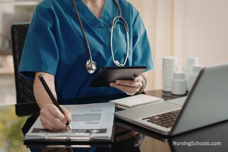 Domestic Violence Nurse documenting findings at a desk and coordinating referrals on paper and computer as part of key job duties and skills.