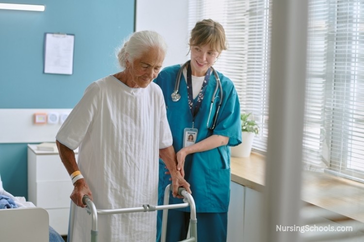 Geriatric Nurse assists an elderly woman using a walker in a hospital room, showing job duties tied to recovery care, mobility support, and discharge planning after illness or surgery.