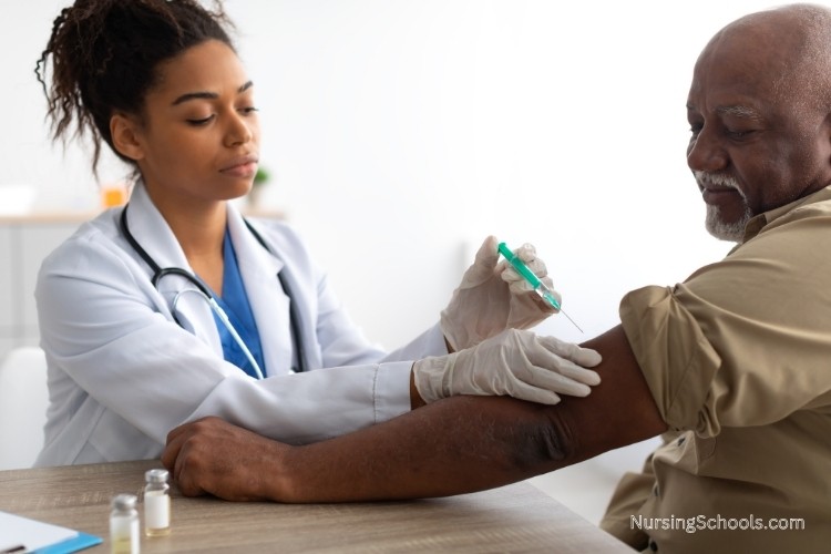 Gerontological Nurse Practitioner injecting medication into the arm of an elderly patient.