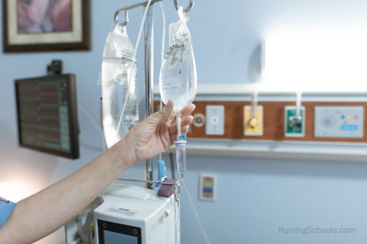 Infusion Nurse administers fluids in a hospital room.