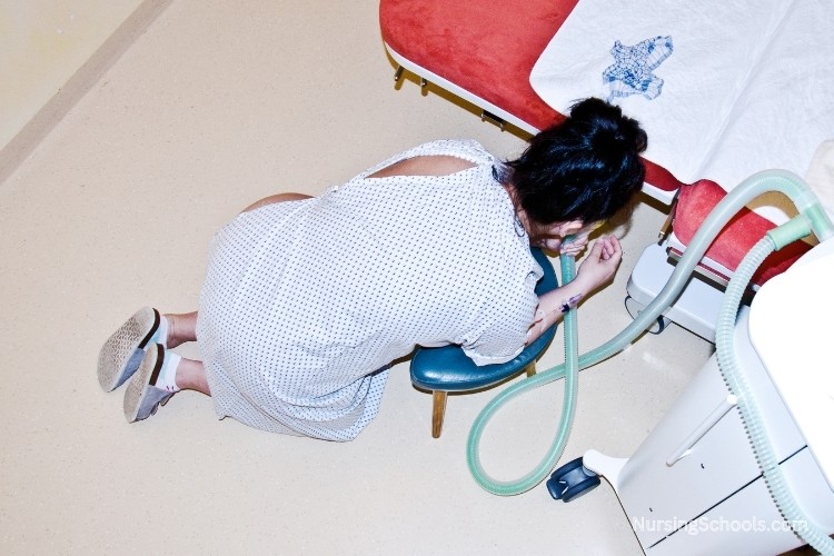 Labor And Delivery Nurse assisting with labor pain management techniques.