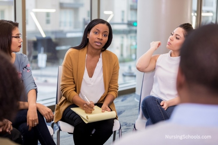 Mental Health Nurse supporting a patient discussion in a community mental health group session.