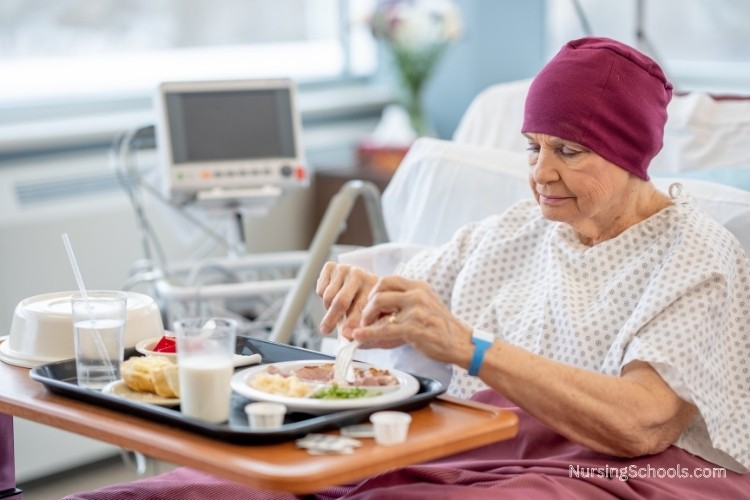 Oncology Nurse provides palliative care to a patient in a hospital room.