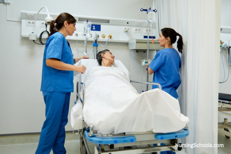 Two operating room nurses caring for a patient in the recovery room.