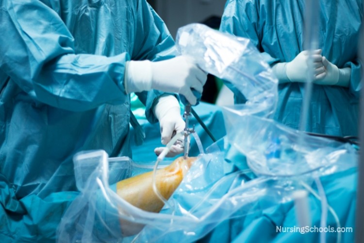 Orthopedic Nurse working closely with an orthopedic surgeon during an orthopedic knee surgery.