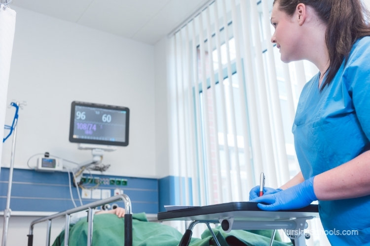 Perianesthesia Nurse monitors a patient in the recovery room after surgery.