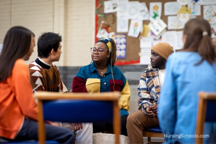 Psychiatric Nurse provides emotional support and guidance to a group of young adults.