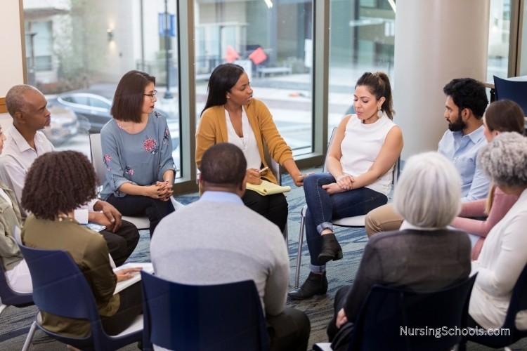 Psychiatric Nurse Practitioner leads a psychotherapy group therapy session.