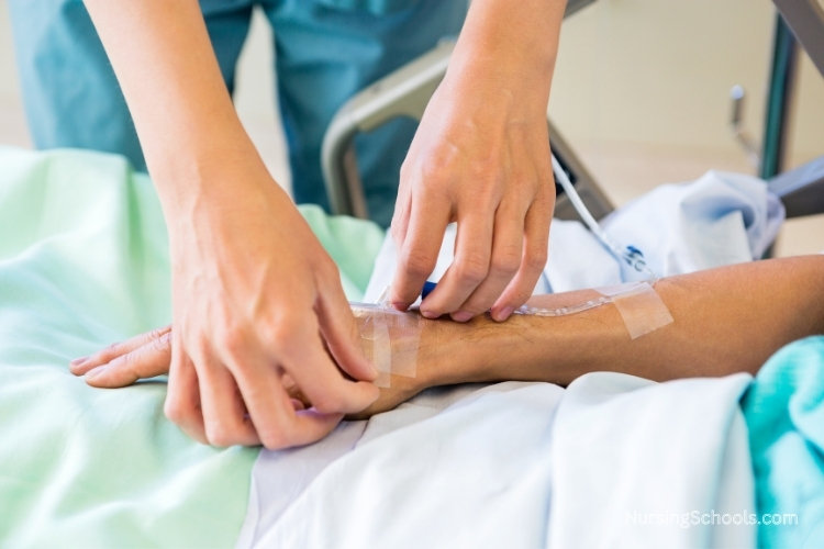 Radiology Nurse inserts an intravenous (IV) line into a patient's arm.