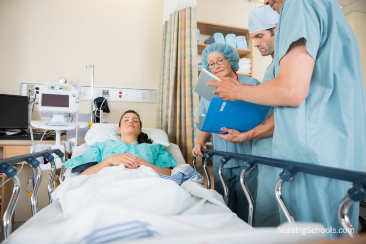 Recovery Room Nurse reviewing patient records with doctor.