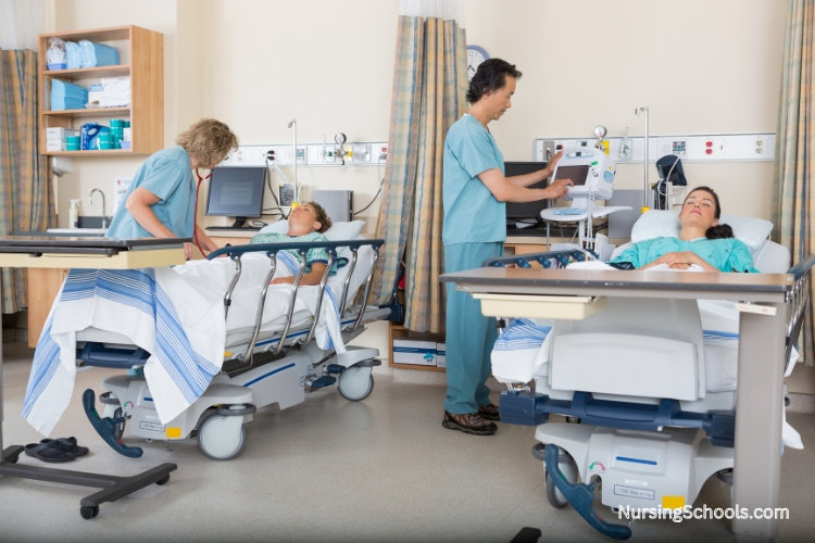 Two Recovery Room Nurses checking vital signs of anesthetized patients.