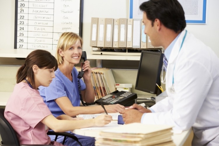 Registered Nurse (RN) supervises other nurses while maintaining patient flow as part of her job duties.