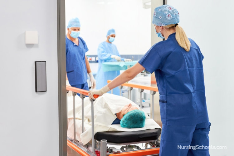 Surgical Nurse rolling a patient into the operating room.