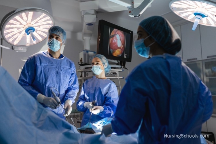 Urology Nurse assists physicians during a cystoscopy procedure.